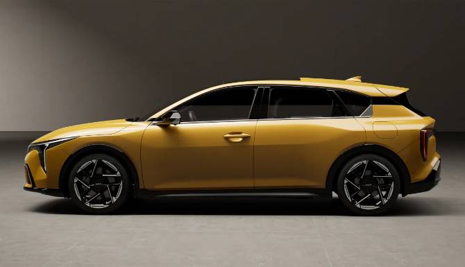 Side view of a yellow, modern estate car with black alloy wheels.