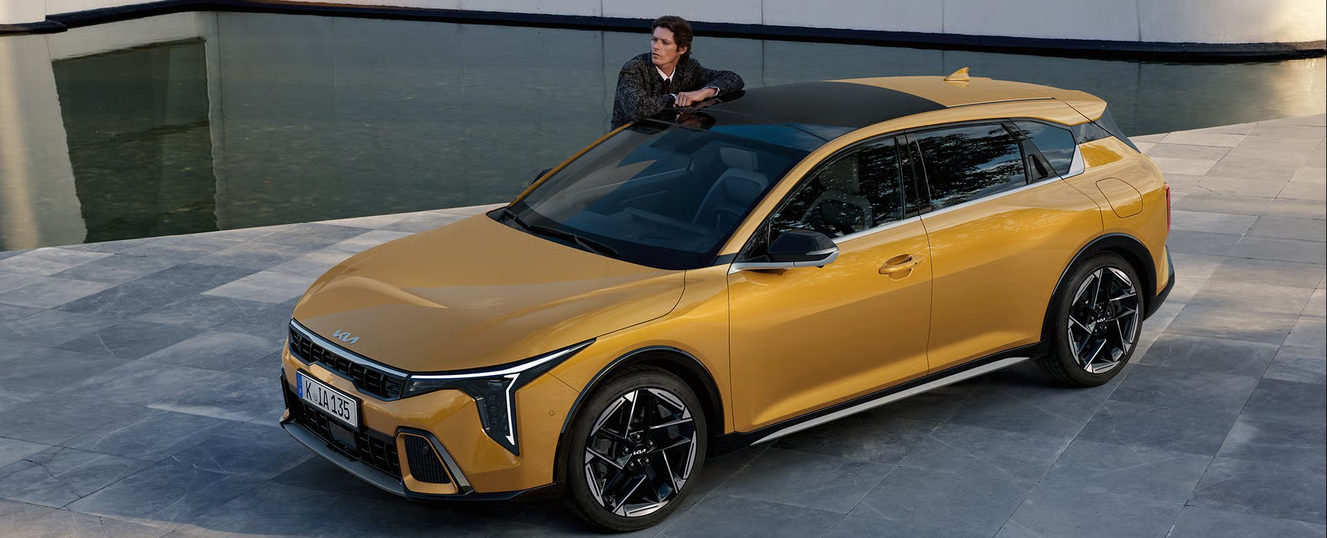 Two cars, one yellow and one grey, parked on a paved surface.