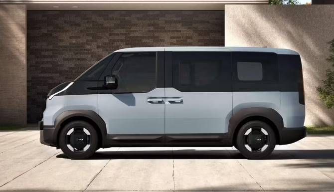 KIA PV5 in grey from the side in a courtyard