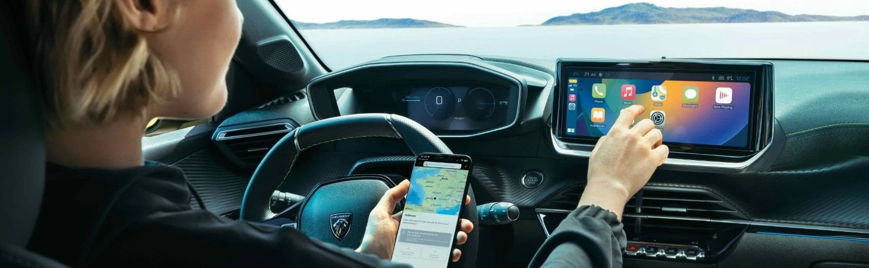 Lady in driver seat using the infotainment