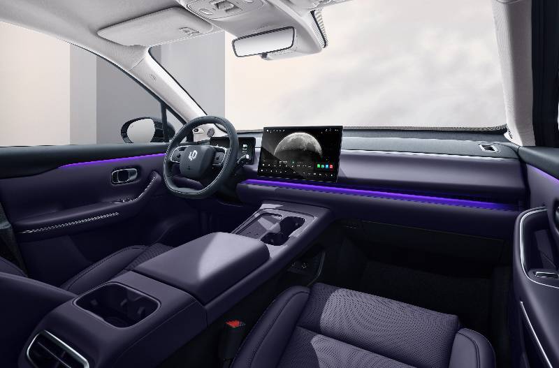 Car interior with purple seats, touchscreen in the centre, and ambient lighting.