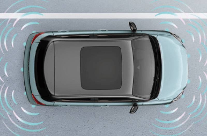 Overhead view of a light blue car with parking sensors activated.