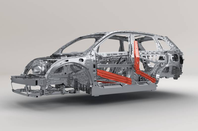 Metal car frame with marked red impact protection bars on side and centre.