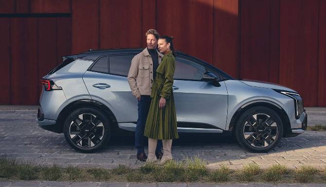 MAN AND WOMAN NEXT TO EACH OTHER NEXT TO CAR