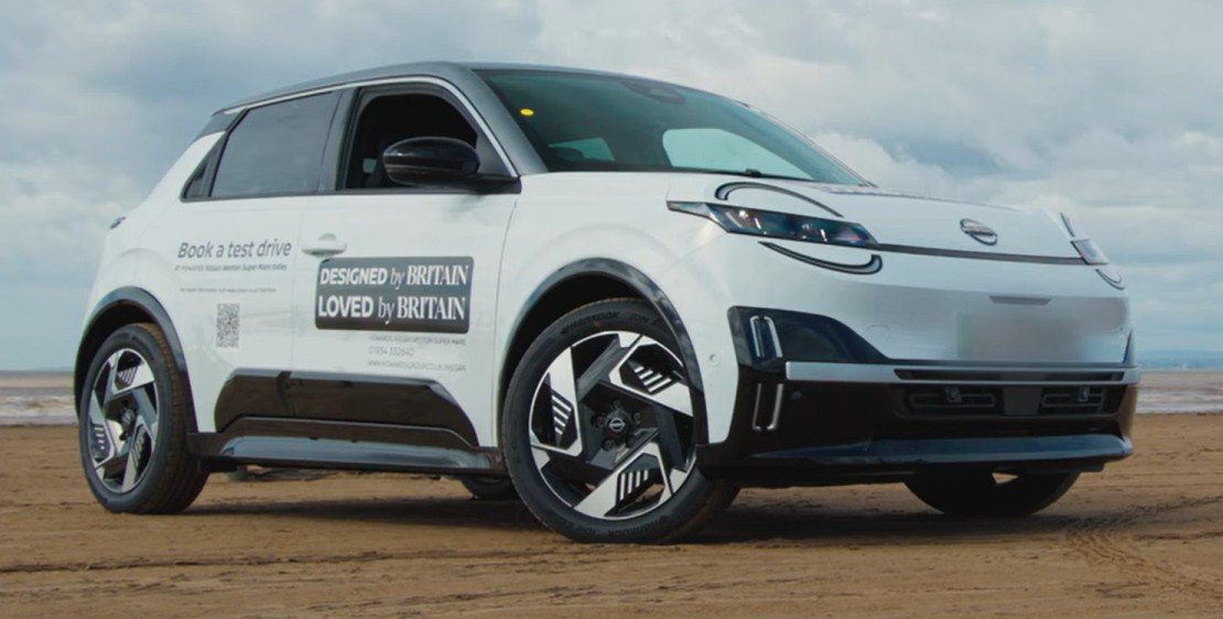 White electric car with promotional text on the side.