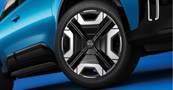 Close-up of a car tyre and rim on a blue vehicle.