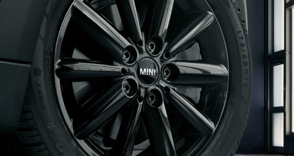 Close-up of a black MINI car wheel with the brand name in the centre.