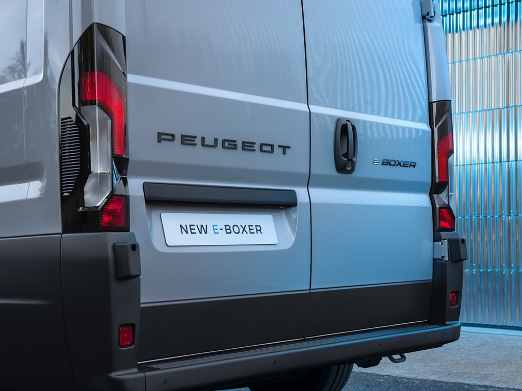 Rear view of a Peugeot E-Boxer van with visible taillights and badge.