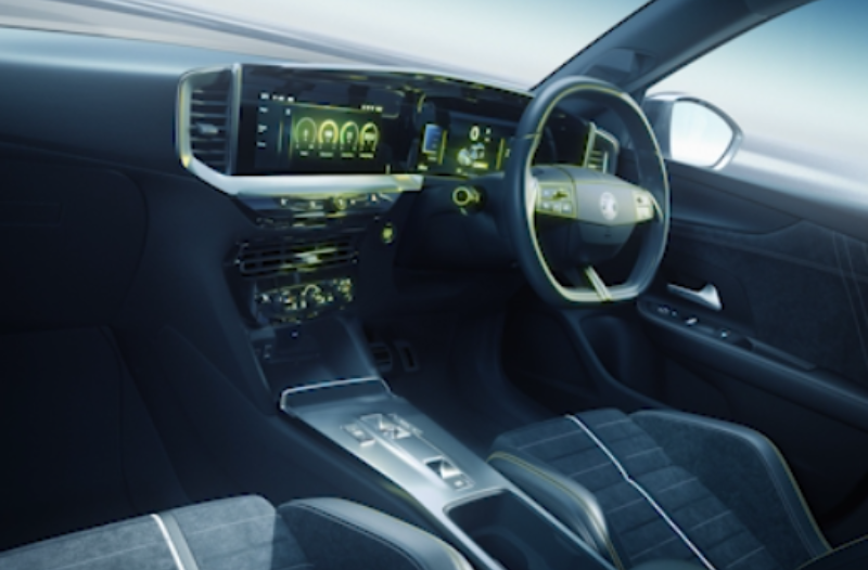 Modern car interior with digital dashboard, steering wheel, and front seats.