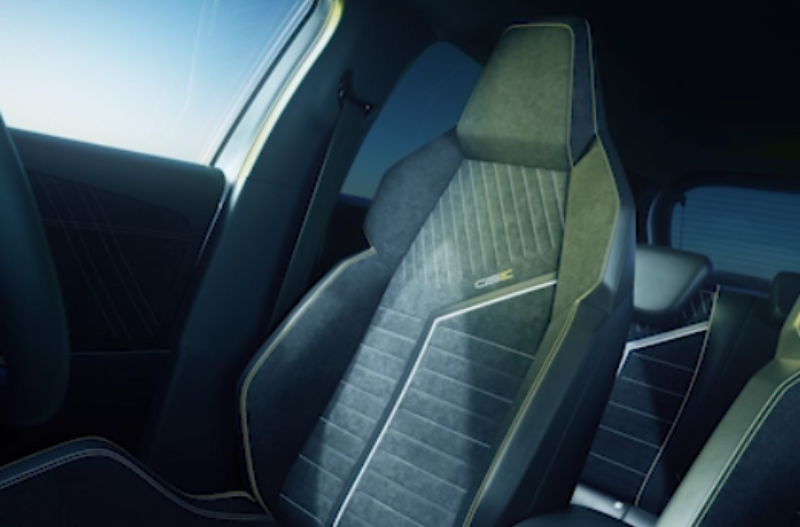 Black car interior with detailed stitching on seats.