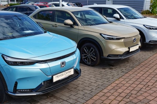 Three Honda cars parked side by side in a dealership.