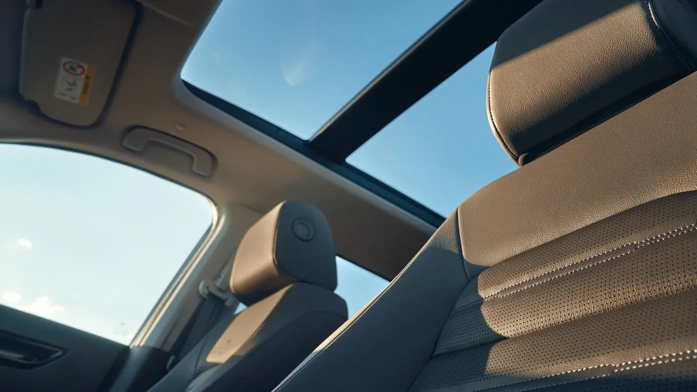 Car interior with sunroof and leather seats.