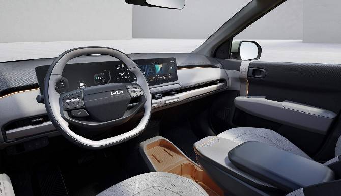 Car interior showing steering wheel and digital dashboard display.
