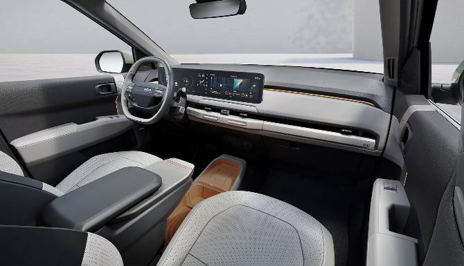 Interior view of a car dashboard with digital display and steering wheel.