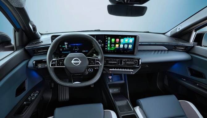 Car interior with digital dashboard, steering wheel, and touchscreen display.