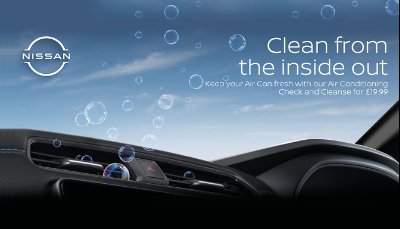 Air vent in a Nissan car with bubbles and promotional text about air conditioning service.