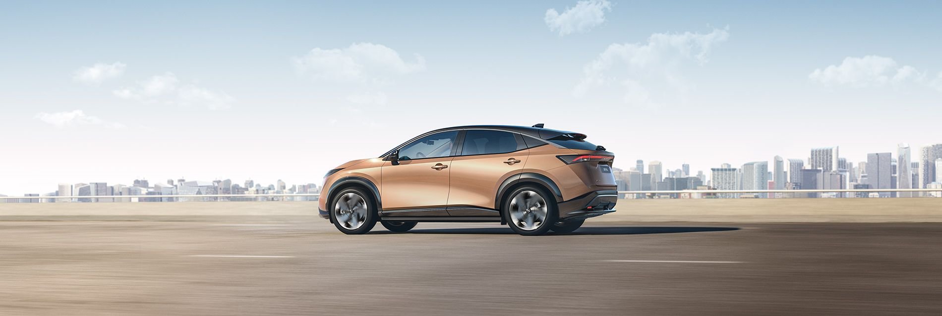 Nissan Ariya driving across a desert road