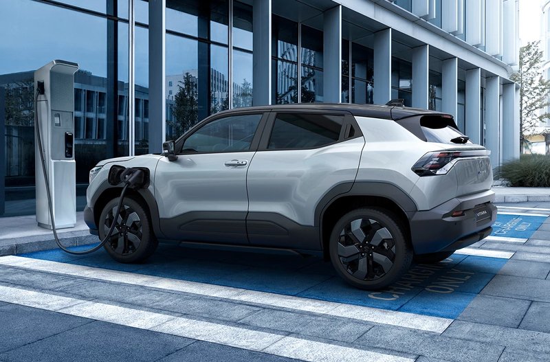 Electric SUV charging at a station.