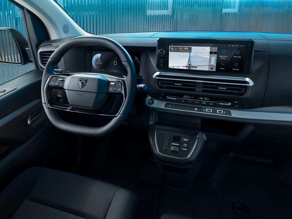 Car interior showing steering wheel and touchscreen display with navigation system.