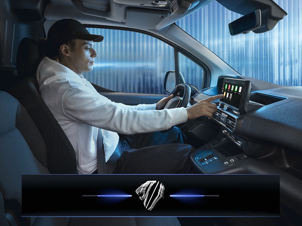 Man using touchscreen in a car's dashboard.