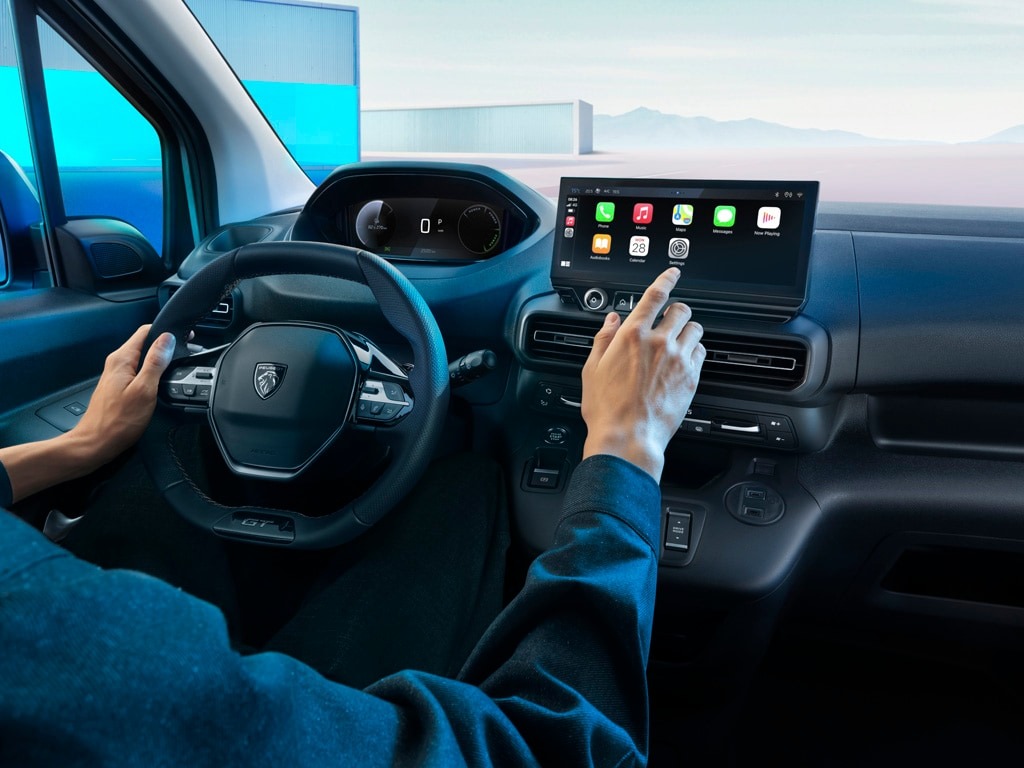 Person interacting with a car's touchscreen infotainment system.