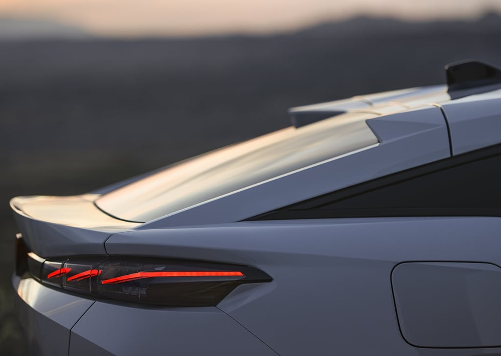 Close-up of a silver car's rear, highlighting the sleek design and tail lights.