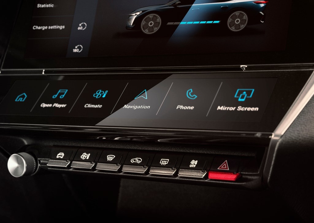 Car dashboard showing infotainment touch screen controls and buttons.
