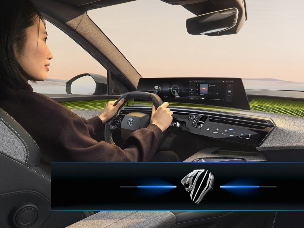 Person driving a car with a digital dashboard display.