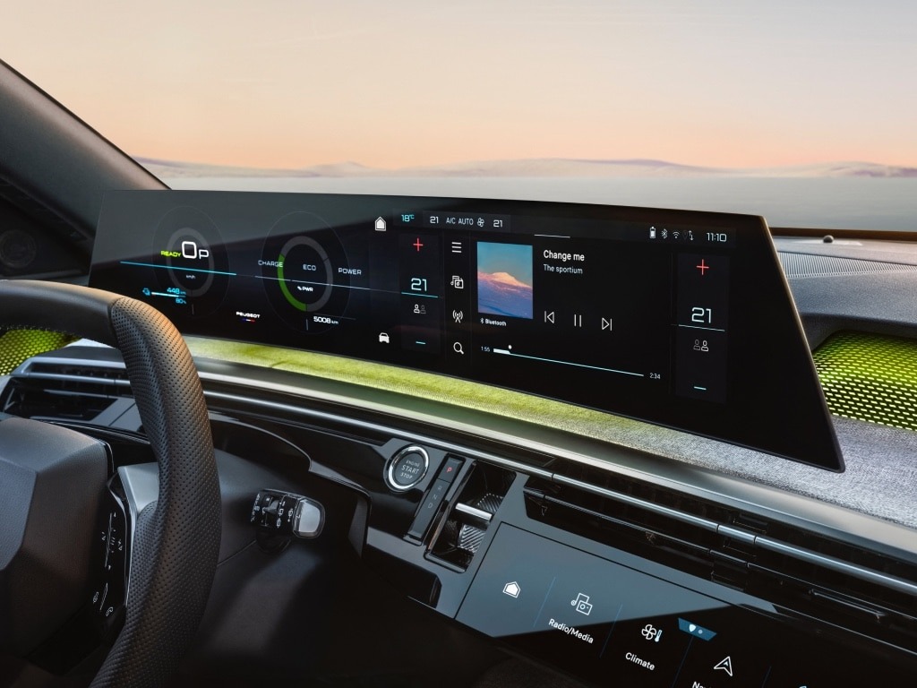 Car dashboard with digital display showing music player and vehicle information.