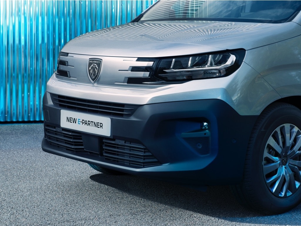 Front view of a silver van with 'New E-Partner' on the number plate.