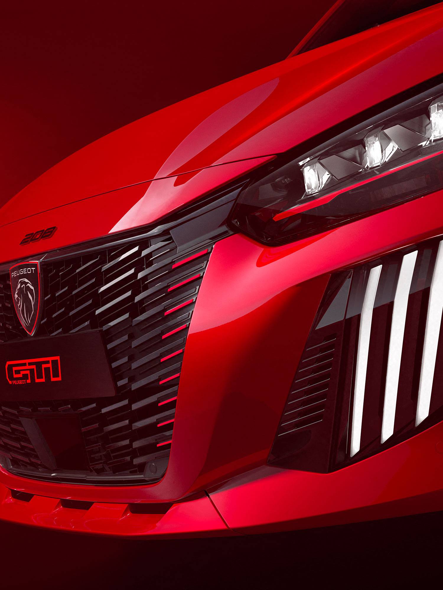 peugeot in red close up of front grille and headlights