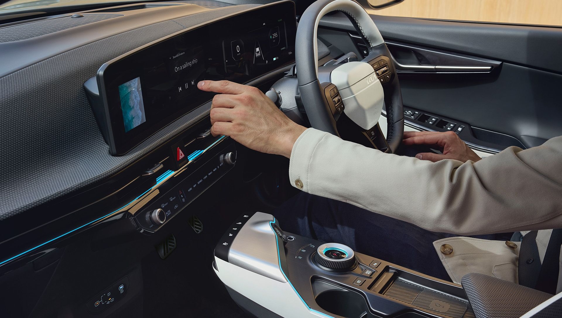 Person using a touchscreen in a car's dashboard.