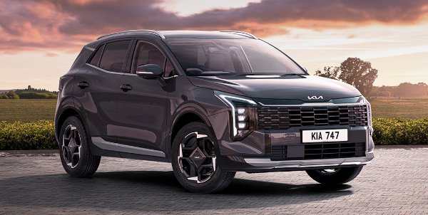 Silver Kia Sportage car parked on a paved area at sunset with KIA 747 plate.