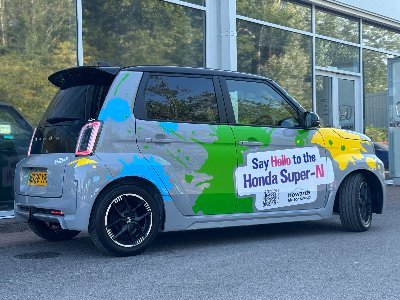 Colourful Honda car with Say Hello to the Honda Super-N signage on the side.