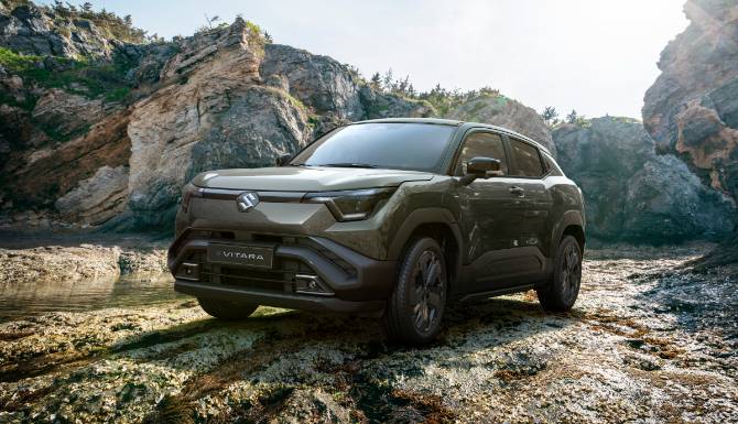 suzuki e-vitara in green on rocky terrain