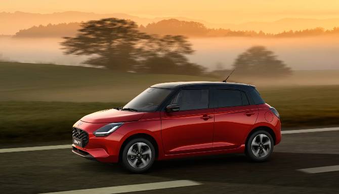 Suzuki swift in red in front of sunset