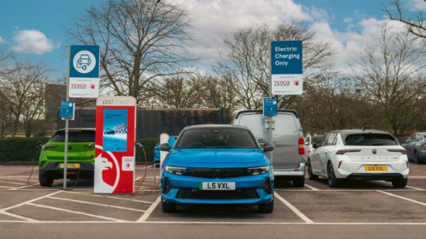 Electric vehicles charging at a Tesco electric car charging station.