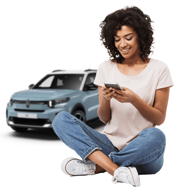 Woman on phone with Citroen C3 behind