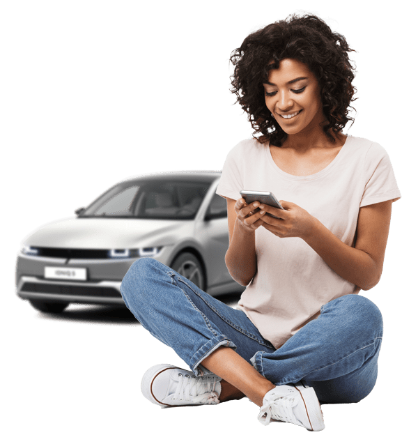 Woman on phone with Hyundai ioniq 5 behind