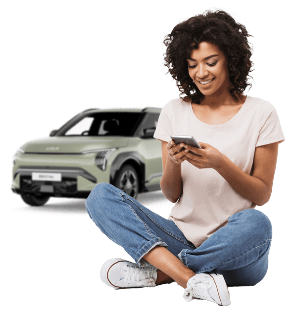 Woman on phone with Kia EV3 behind