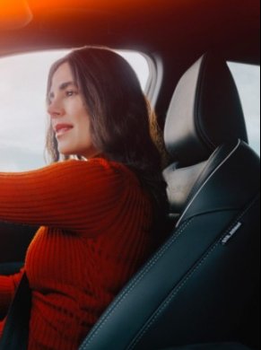 Woman sat in the drivers seat of a nissan